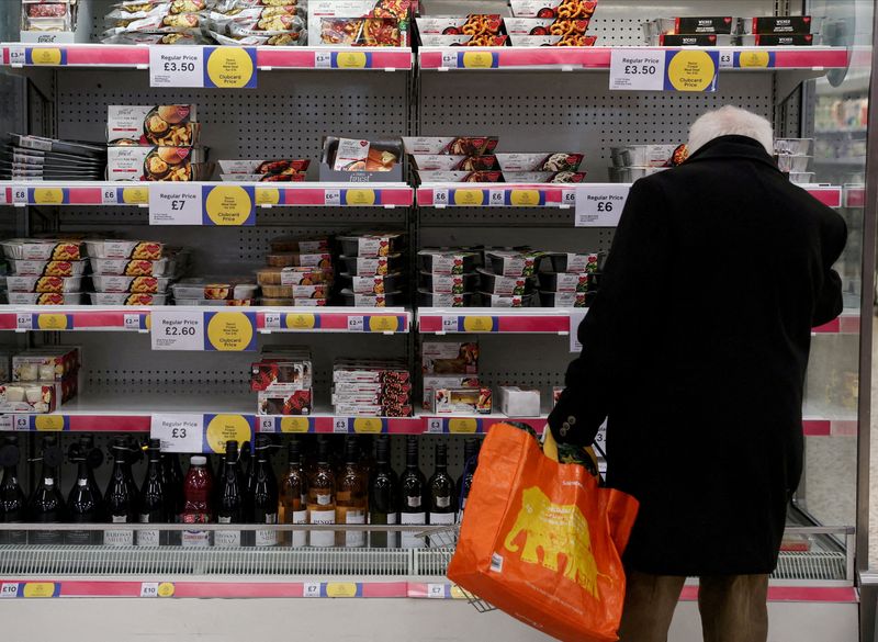 &copy; Reuters. FILE PHOTO: A man shops inside a branch of a Tesco Extra Supermarket in London, Britain, February 10, 2022. Picture taken February 10, 2022. REUTERS/Paul Childs//File Photo