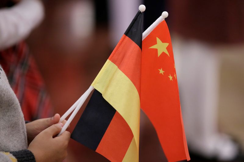 &copy; Reuters. FILE PHOTO: A student holds flags of China and Germany before a welcome ceremony hosted by China's President Xi Jinping for German President Frank-Walter Steinmeier at the Great Hall of the People in Beijing, China December 10, 2018. REUTERS/Jason Lee