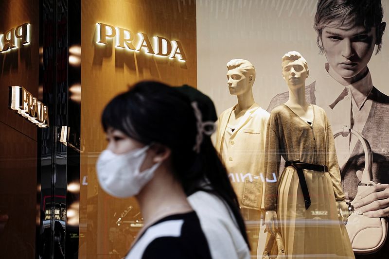 &copy; Reuters. FILE PHOTO: Shoppers walk past a Prada luxury store at Tsim Sha Tsui district in Hong Kong, China February 15, 2023. REUTERS/Lam Yik