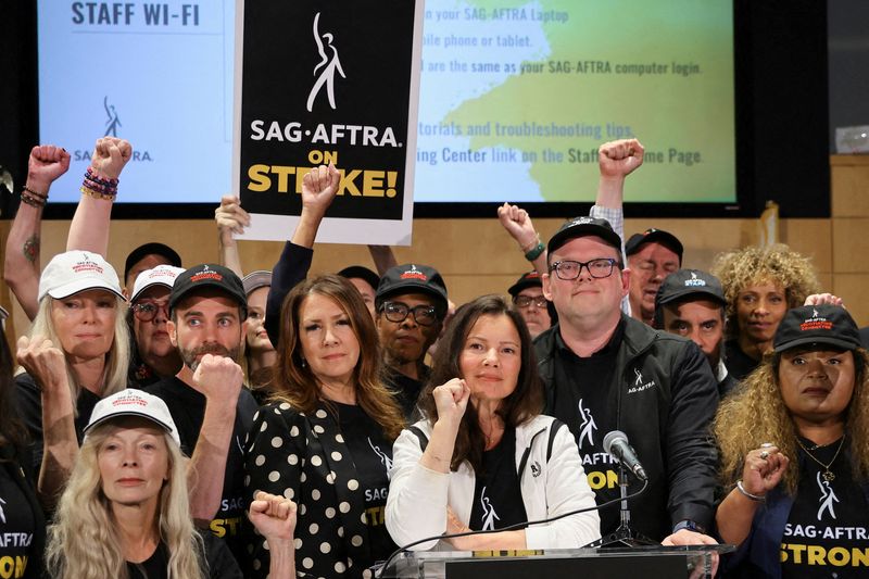 &copy; Reuters. SAG-AFTRA union President Fran Drescher, Duncan Crabtree-Ireland, SAG-AFTRA National Executive Director and Chief Negotiator, and union members gesture at SAG-AFTRA offices after negotiations ended with the Alliance of Motion Picture and Television Produc