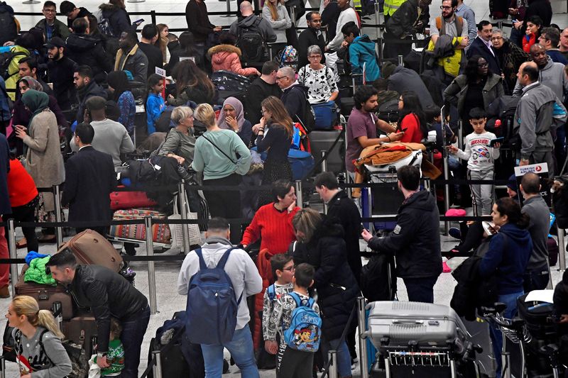 &copy; Reuters. Photo d'archives: Des passagers attendent dans une file d'attente pour l'enregistrement dans le bâtiment du terminal sud de l'aéroport de Gatwick, à Gatwick, en Grande-Bretagne. /Photo prise le 21 décembre 2018/REUTERS/Toby Melville 