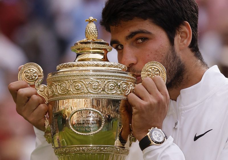&copy; Reuters. Tennis - Wimbledon - All England Lawn Tennis and Croquet Club, London, Britain - July 16, 2023 Spain's Carlos Alcaraz celebrates with the trophy after winning his final match against Serbia's Novak Djokovic REUTERS/Andrew Couldridge