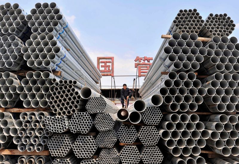 &copy; Reuters. FILE PHOTO: A labourer piles up steel pipes at a steel and iron factory in Shenyang, Liaoning province April 23, 2010.  REUTERS/Sheng Li/File Photo
