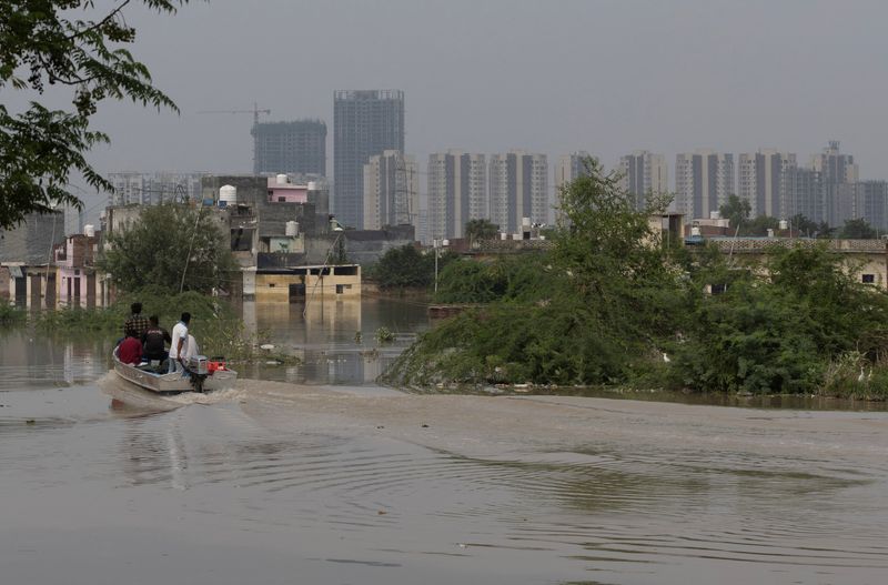 People living near Yamuna River in New Delhi return home as waters recede