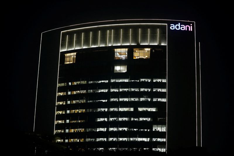 &copy; Reuters. FILE PHOTO-The logo of the Adani Group is seen on the facade of its Corporate House on the outskirts of Ahmedabad, India, January 27, 2023. REUTERS/Amit Dave/file photo