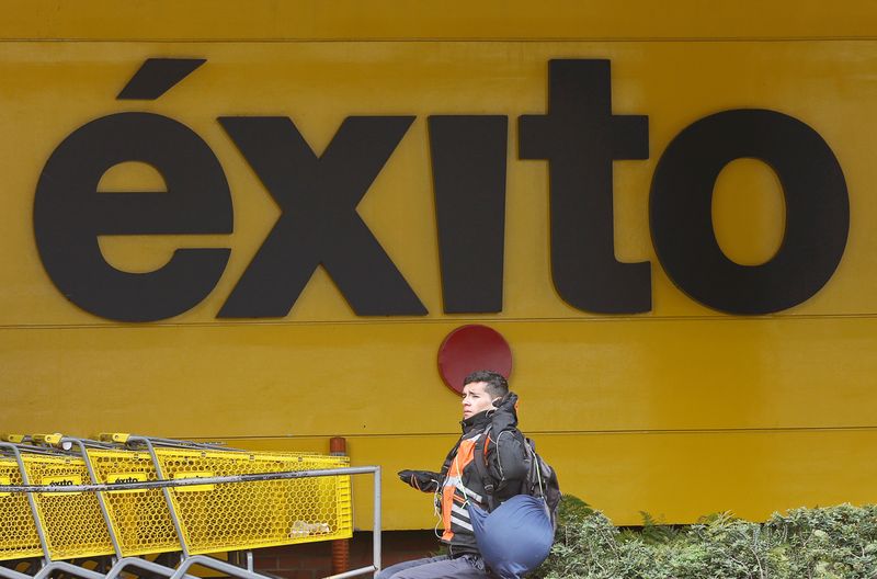 &copy; Reuters. A man sits in front of an Exito supermarket logo in Bogota, Colombia March 1, 2019. REUTERS/Luisa Gonzalez