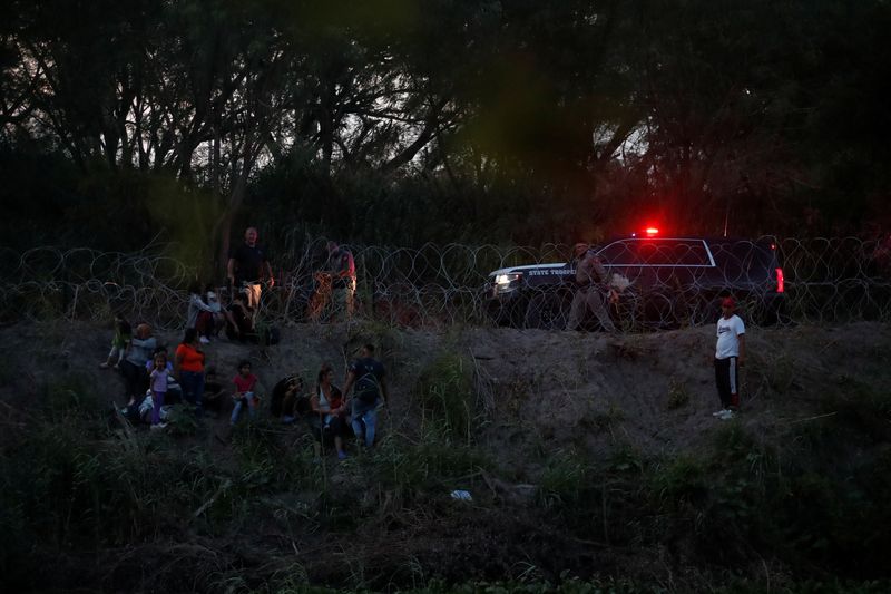 &copy; Reuters. Asylum seekers gather after crossing the Rio Grande river in an attempt to enter the United States, as seen from Matamoros, at a makeshift camp, in Matamoros, Mexico June 21, 2023. REUTERS/Daniel Becerril/File Photo