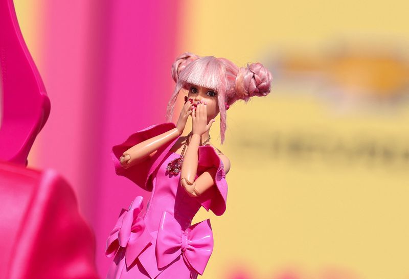 © Reuters. FILE PHOTO: A fan takes a photo of a Barbie doll at the world premiere of the film 