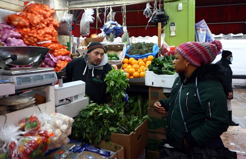 &copy; Reuters. FILE PHOTO: A woman looks to buy fruit and vegetables at a grocery shop in Lewisham Market, south east London, Britain, March 9, 2023. REUTERS/Hannah McKay/File Photo