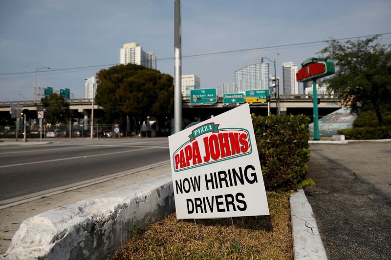 &copy; Reuters. FILE PHOTO: A "Now Hiring" sign advertising jobs at Papa Johns is seen along a street, as the spread of the coronavirus disease (COVID-19) continues, in downtown Miami, Florida, U.S. April 13, 2020. REUTERS/Marco Bello/File Photo