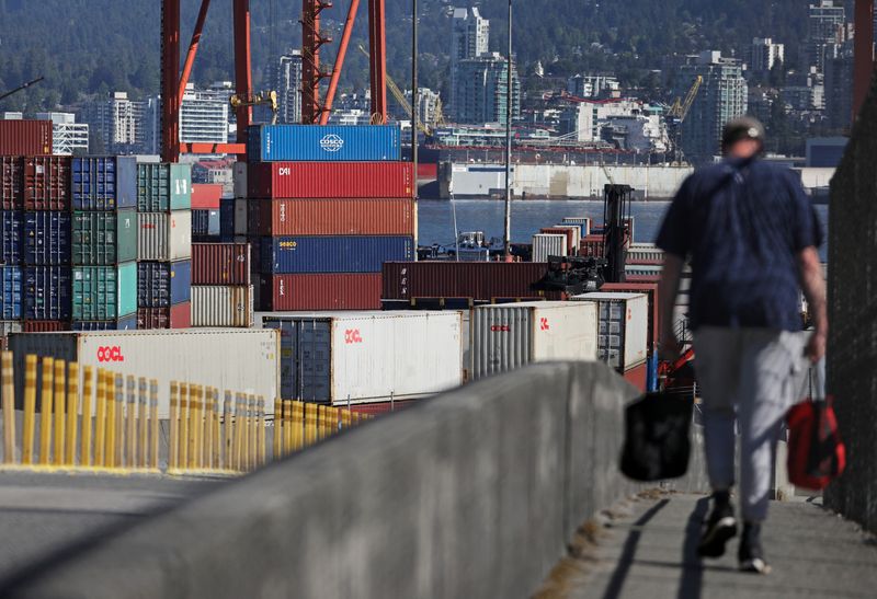 © Reuters. A worker walks to the Port of Vancouver as International Longshore and Warehouse Union (ILWU) union members returned to clear a backlog of containers and bulk cargo from a 13-day strike in Vancouver, British Columbia, Canada, July 20, 2023. REUTERS/Chris Helgren