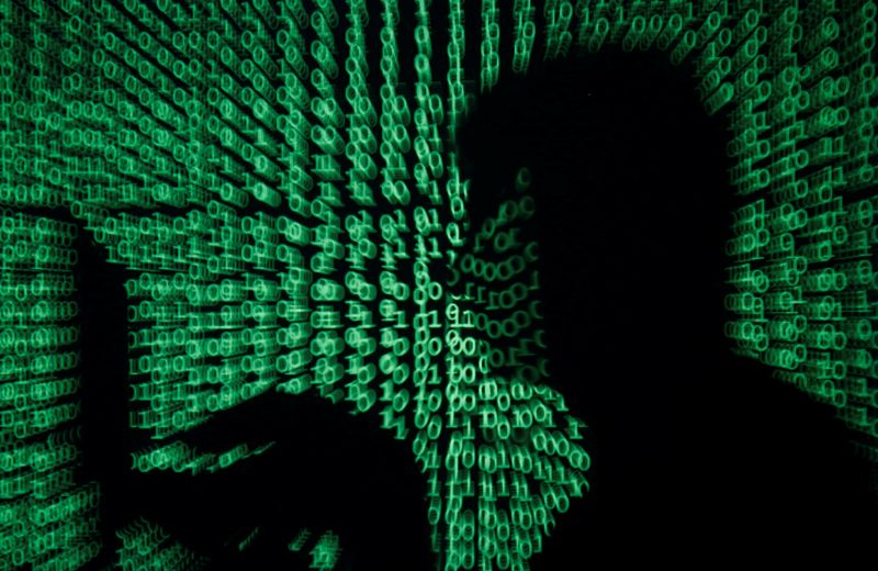 &copy; Reuters. A man holds a laptop computer as cyber code is projected on him in this illustration picture taken on May 13, 2017. REUTERS/Kacper Pempel/Illustration/File photo