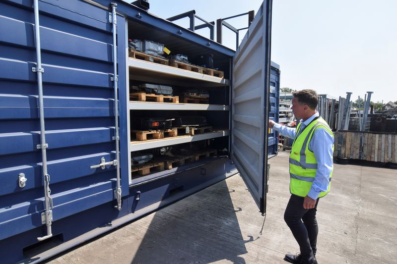 &copy; Reuters. FILE PHOTO: Marc Trent, CEO of vehicle dismantler company Charles Trent Ltd, opens up a specially-built, fire-safe container for batteries salvaged from written-off electric vehicles and hybrids in Poole, Britain, June 7, 2023. REUTERS/Nick Carey