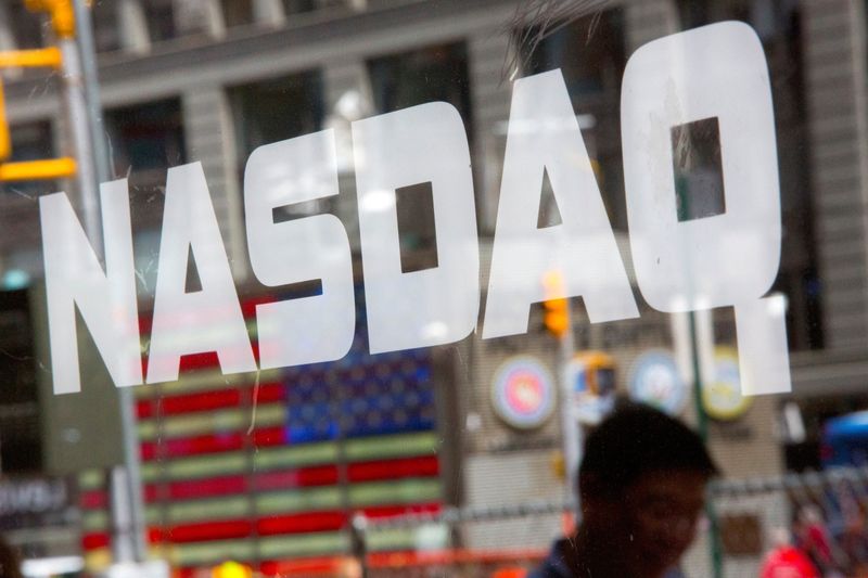 &copy; Reuters. FILE PHOTO: A man walks past the Nasdaq MarketSite in New York's Times Square, August 23, 2013. Stocks inched higher on Friday as trading resumed without interruption a day after the Nasdaq stock exchange suffered an unprecedented, three-hour trading halt