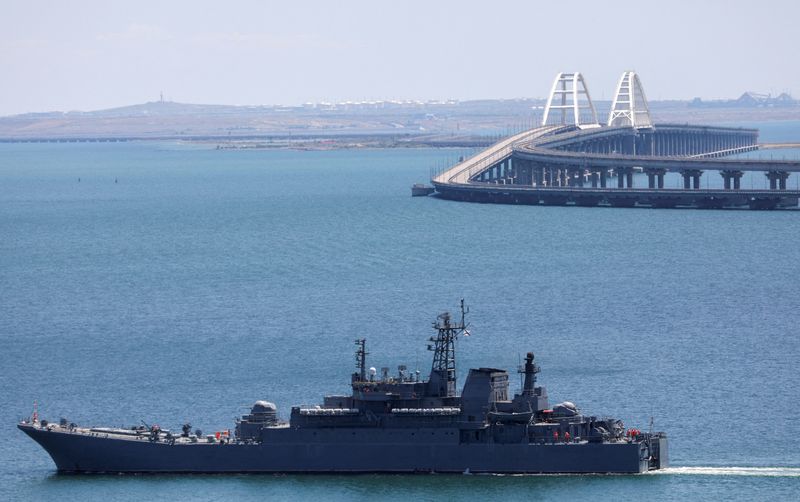 &copy; Reuters. FILE PHOTO: A Russian Navy amphibious landing ship that was deployed to transport cars across the Kerch Strait, moves near the Crimean Bridge, a section of which was damaged by an alleged overnight attack, as seen from the city of Kerch, Crimea, July 17, 