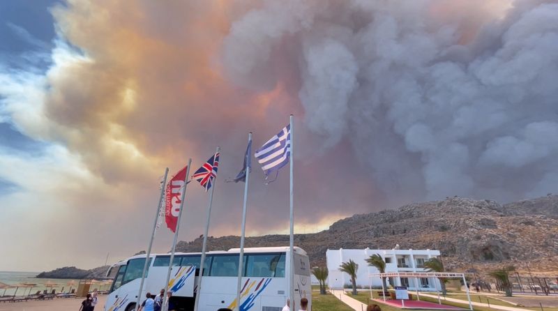 &copy; Reuters. Smoke rises from a wildfire in Rhodes Island, Greece, July 22, 2023 in this screengrab taken from a social media video. Tiktok/@blairsbrainiacs/via REUTERS  