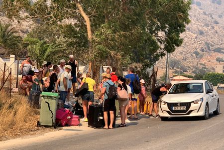 Tourists flee wildfires on Greek island of Rhodes By Reuters