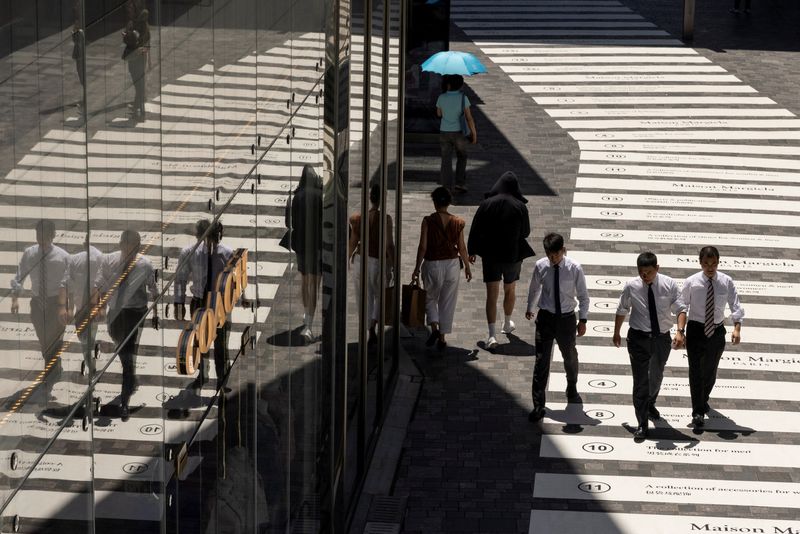 &copy; Reuters. FILE PHOTO: People walk in a shopping district in Beijing, China, July 14, 2023. REUTERS/Thomas Peter/File Photo