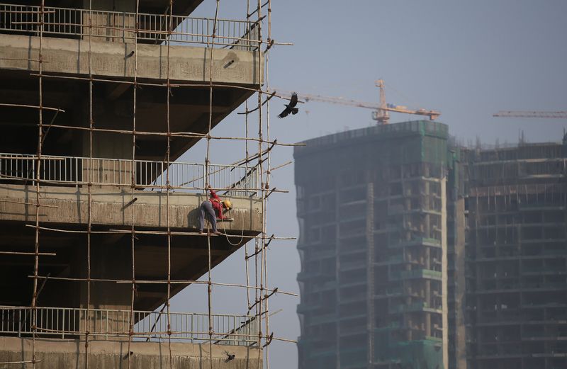 &copy; Reuters. A labourer stands on wooden scaffolding as he works at the construction site of a commercial building in Mumbai's central financial district January 16, 2015. REUTERS/Danish Siddiqui/File Photo 