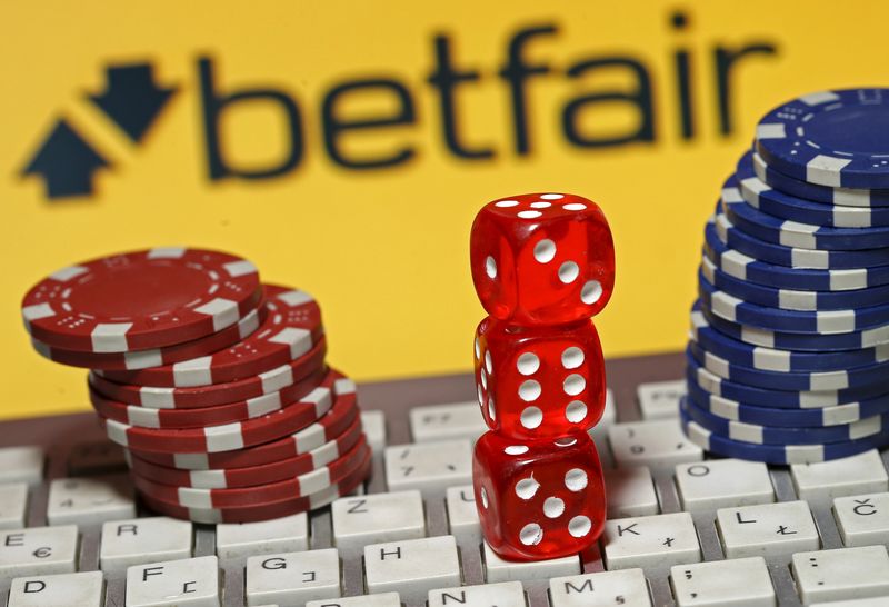 &copy; Reuters. Betfair logo is seen behind a keyboard, gambling dice and chips in this illustration taken in Sarajevo, September 10, 2015. REUTERS/Dado Ruvic