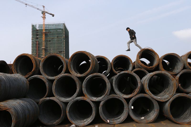 &copy; Reuters. FILE PHOTO: A customer jumps on piles of steel coils at a steel market in Jiaxing, Zhejiang province February 21, 2014. REUTERS/William Hong/File Photo