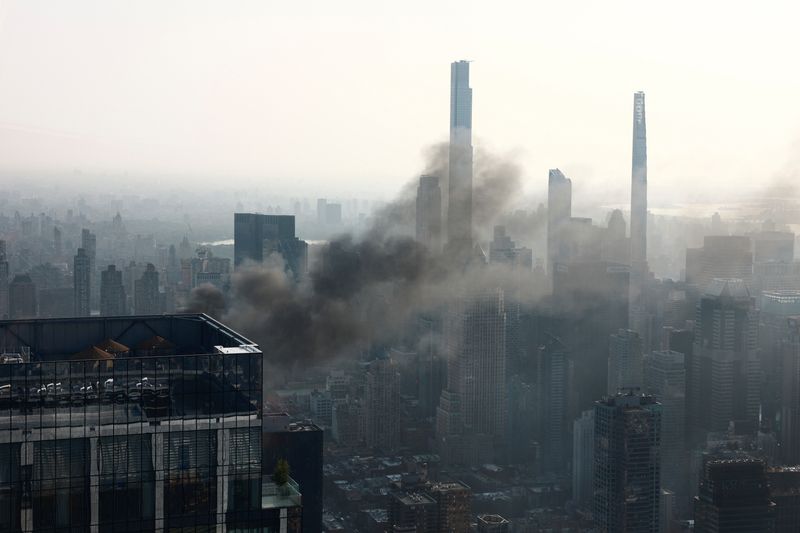 New York crane snaps and crashes into street, injuring six