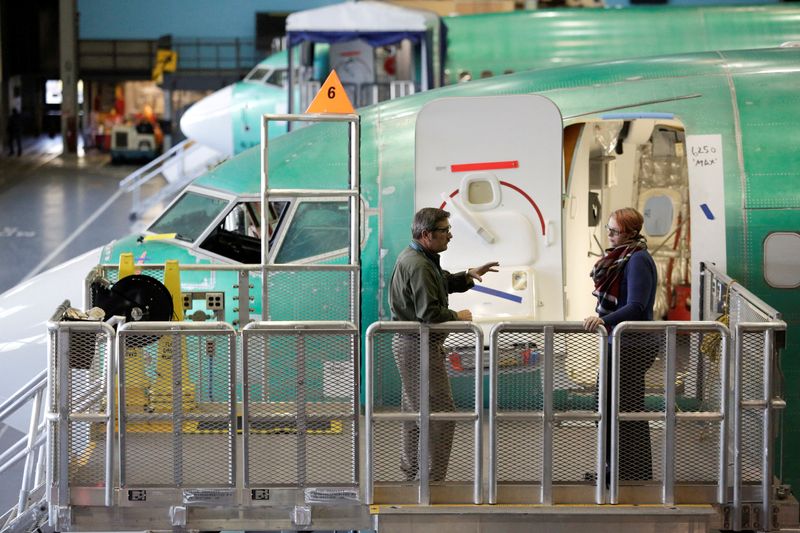 &copy; Reuters. FILE PHOTO: Workers are pictured next to Boeing's 737 MAX-9 under construction at their production facility in Renton, Washington, U.S., February 13, 2017. Picture taken February 13, 2017. REUTERS/Jason Redmond/File Photo