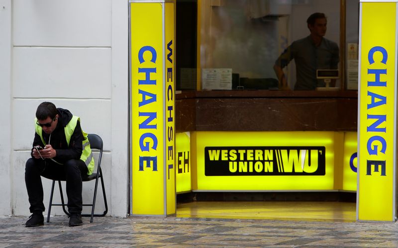 &copy; Reuters. A man sits on a chair next to Western Union currency exchange office in Prague, Czech Republic, September 8, 2017.   REUTERS/David W Cerny