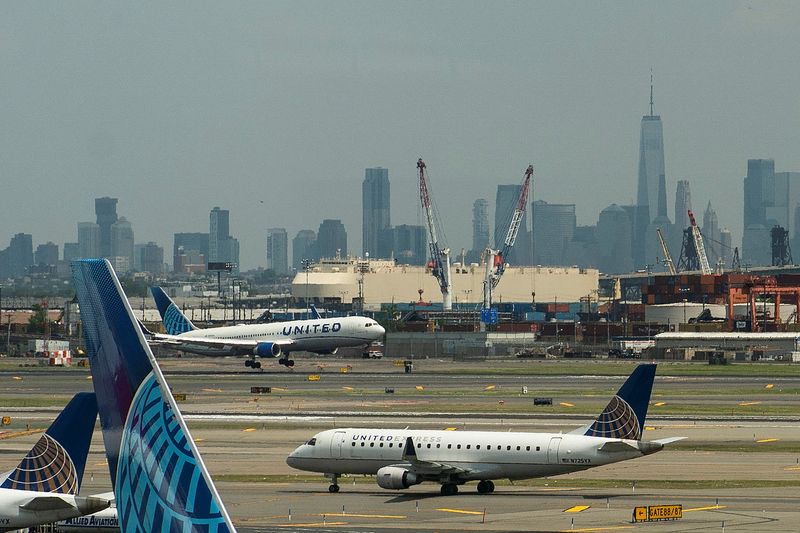 &copy; Reuters. The One World trace Center and the New York skyline are seen while United Airlines planes use the tarmac as pilots from United Airlines take part in an informational picket at Newark Liberty International Airport in Newark, New Jersey, U.S., May 12, 2023.