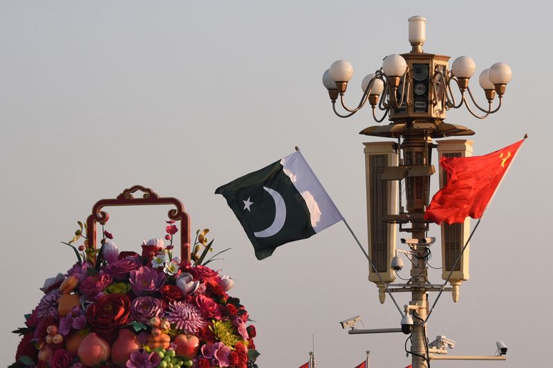 © Reuters. FILE PHOTO: Pakistani and Chinese national flags flutter next to an installation featuring a giant flower basket at the Tiananmen Square in Beijing, China October 7, 2019. Picture taken October 7, 2019. REUTERS/Stringer 