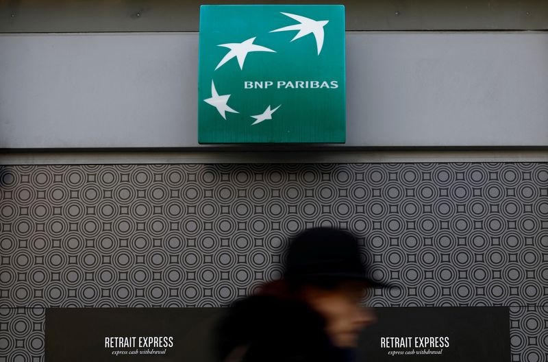 &copy; Reuters. FILE PHOTO-A woman walks past a BNP Paribas bank sign on an office building in Nantes, France, March 16, 2023. REUTERS/Stephane Mahe/File photo