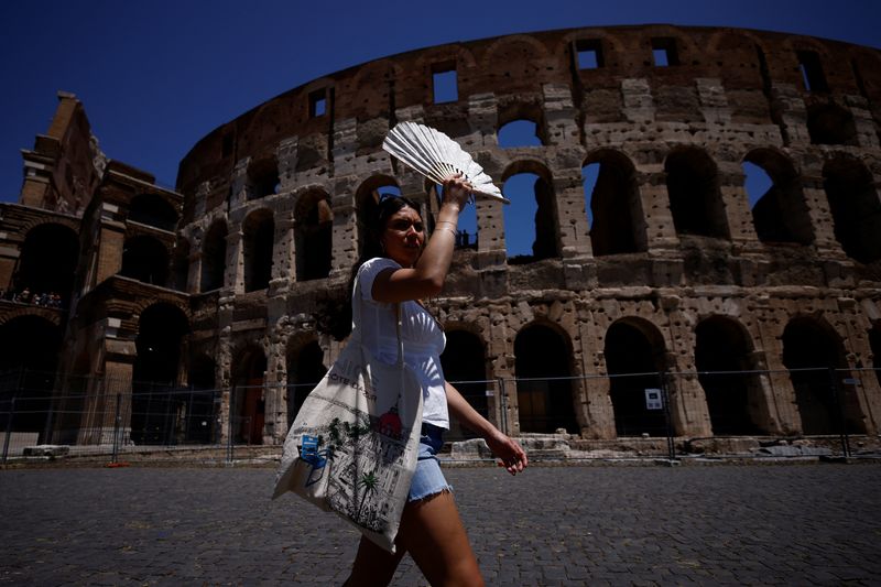 &copy; Reuters. FILE PHOTO: Michelle from the U.S. uses a fan to shelter from the sun near the Colosseum during a heatwave across Italy, in Rome, Italy July 11, 2023. REUTERS/Guglielmo Mangiapne/File Photo