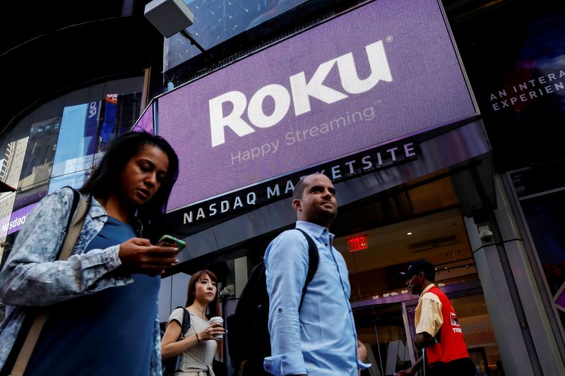 &copy; Reuters. People pass by a video sign display with the logo for Roku Inc, a Fox-backed video streaming firm, that held it's IPO at the Nasdaq Marketsite in New York, U.S., September 28, 2017. REUTERS/Brendan McDermid