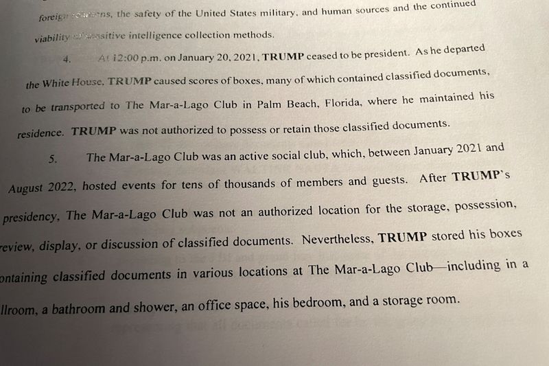 &copy; Reuters. A page from a copy of a superceding indictment is seen, after U.S. prosecutors broadened their criminal case against Donald Trump as they charged a second of his employees with helping the former president evade officials who were trying to recover sensit