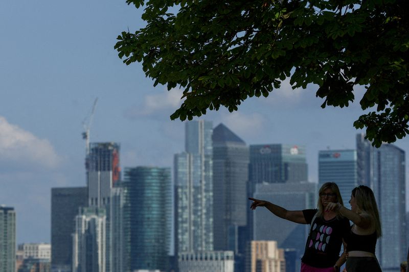 &copy; Reuters. FILE PHOTO: People look out from Greenwich Park, with Canary Wharf in the distance, in London, Britain June 22, 2023. REUTERS/Hannah McKay/File Photo
