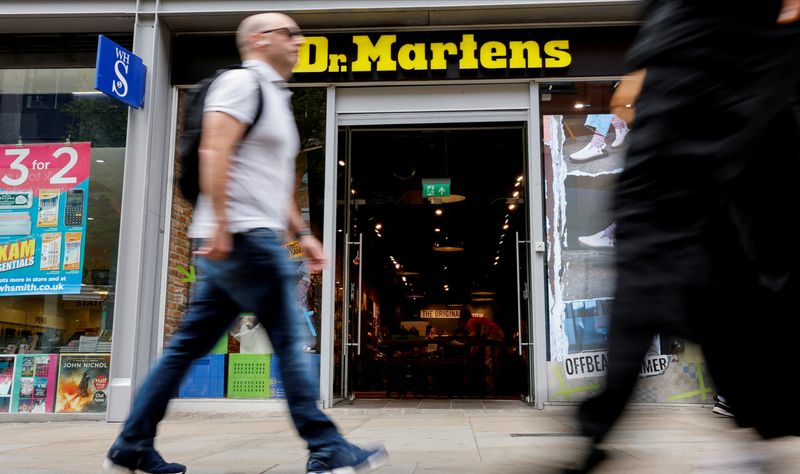 &copy; Reuters. FILE PHOTO: People walk past a Dr. Martens store in Manchester, Britain, May 26, 2023. REUTERS/Jason Cairnduff/File Photo