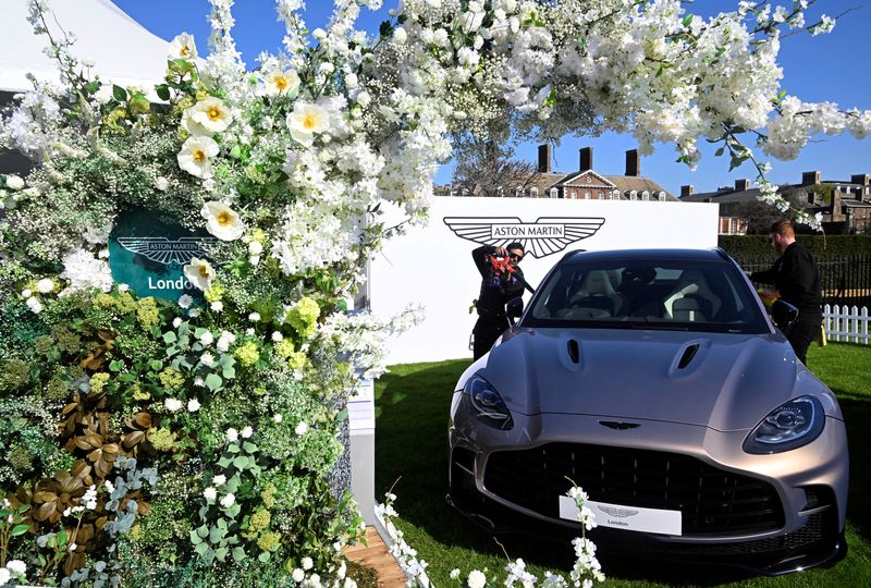 &copy; Reuters. FILE PHOTO: Workers clean an Aston Martin car on display at the Salon Prive, a three day automobile event which showcases both new and classic, luxury and sports vehicles, at the Royal Chelsea Hospital in London, Britain, April 20, 2023. REUTERS/Toby Melv