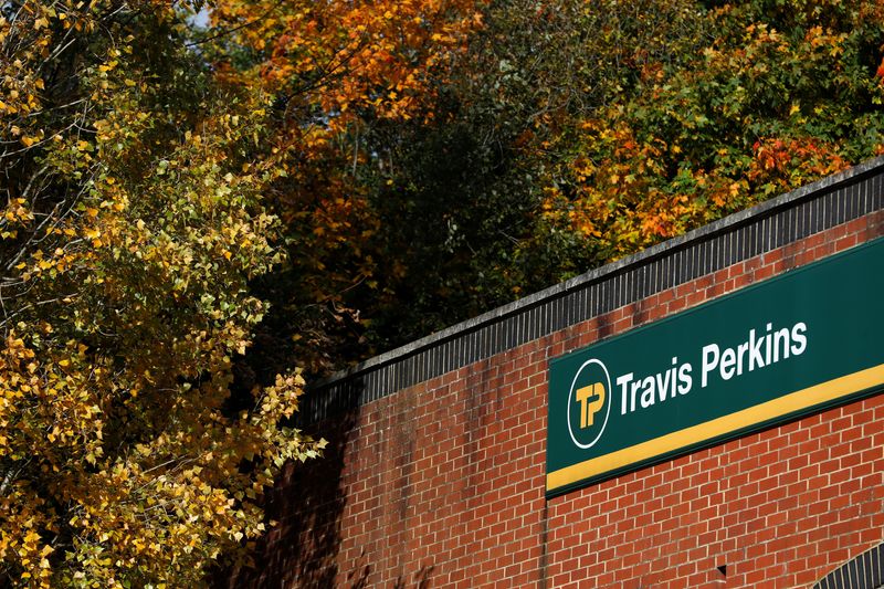 &copy; Reuters. FILE PHOTO-A signage is pictured at a building of Travis Perkins, a timber and building merchants yard in St Albans, Britain October 22, 2020. REUTERS/Paul Childs/File Photo
