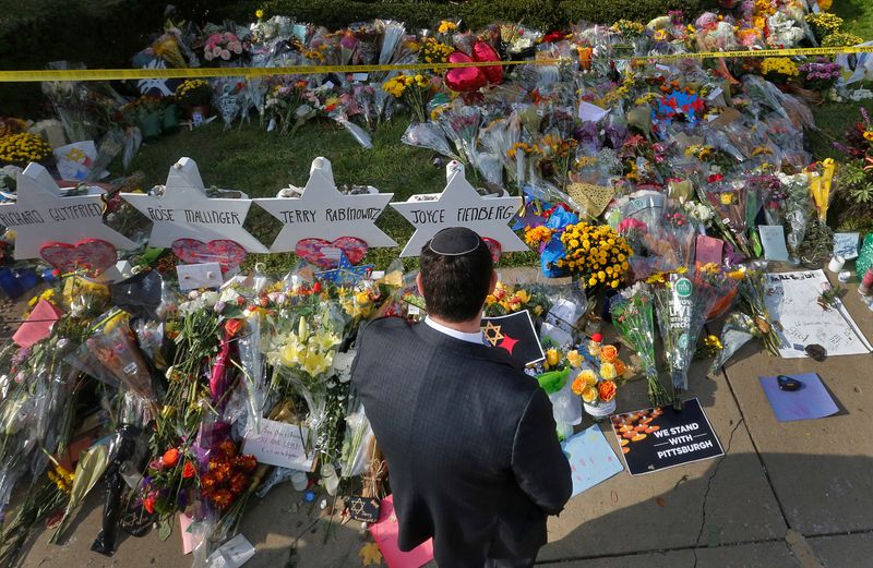 © Reuters. A man prays at a makeshift memorial outside the Tree of Life synagogue in Pittsburgh, Pennsylvania, October 31, 2018. REUTERS/Cathal McNaughton