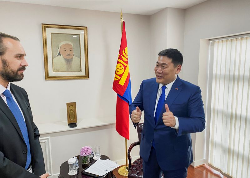 &copy; Reuters. Mongolian Prime Minster Oyun-Erdene Luvsannamsrai gestures in front of Mongolia's flag and a portrait of the country's national hero Genghis Khan while speaking to Reuters correspondent Simon Lewis in an interview at the Mongolian embassy in Washington, U