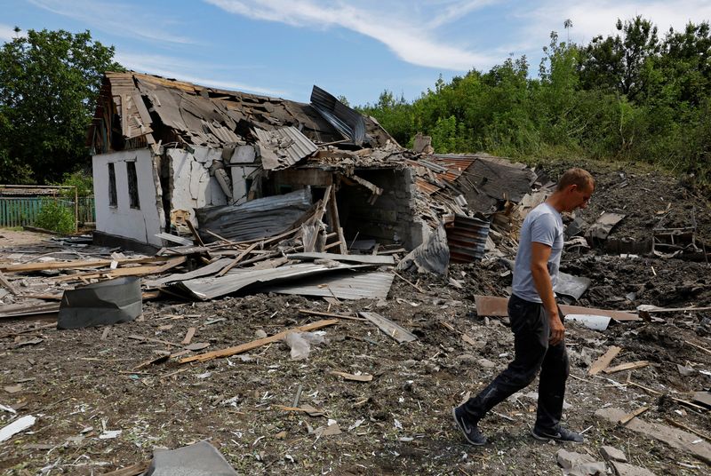 © Reuters. FILE PHOTO: Local resident Sergei Gromenko, 35, walks next destroyed house of his female neighbour who was killed during a shelling in the course of Russia-Ukraine conflict in Donetsk, Russian-controlled Ukraine, July 31, 2023. REUTERS/Alexander Ermochenko