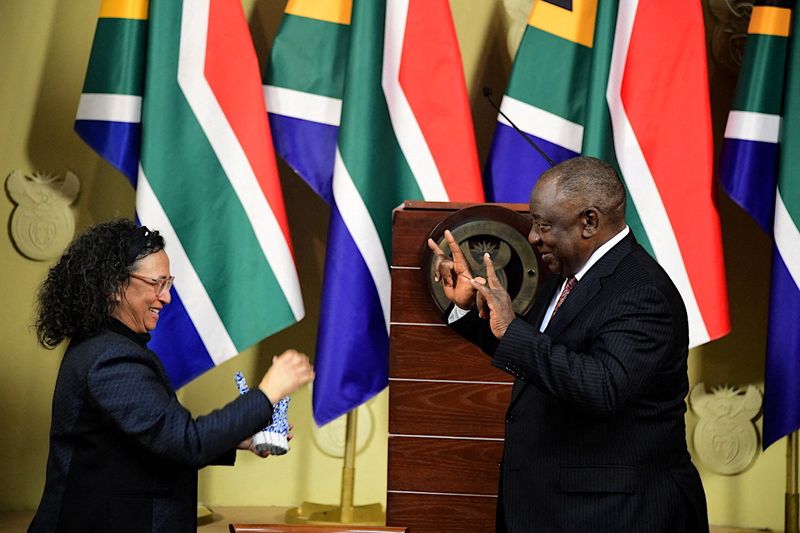 &copy; Reuters. FILE PHOTO: South African President Cyril Ramaphosa gestures in sign language after he signed legislation into law last month recognising sign as the country's 12th official language, alongside English, Zulu, Afrikaans and others, to help protect the righ