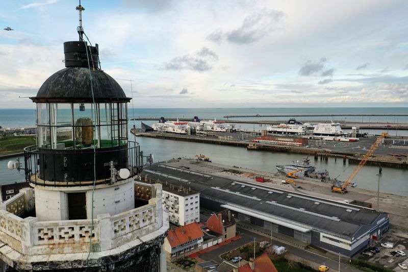 &copy; Reuters. FILE PHOTO: The ferry terminal is seen behind the top of lighthouse in Calais, France, December 30, 2020. Picture taken with a drone. REUTERS/Pascal Rossignol/File Photo