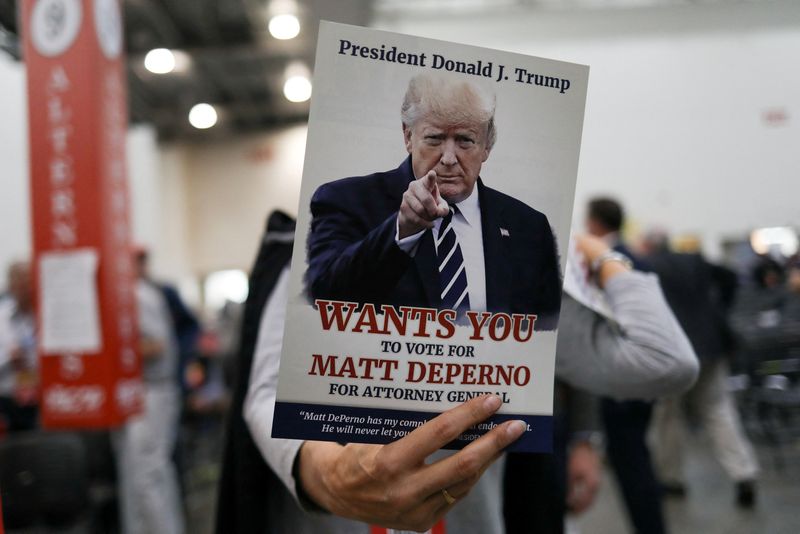 &copy; Reuters. FILE PHOTO: A Republican attendee holds a sign in support of Matt DePerno, a candidate for attorney general, at the "Empowering Michigan" GOP convention at DeVos Place in Grand Rapids, Michigan, U.S., April 23, 2022.  REUTERS/Emily Elconin/File Photo