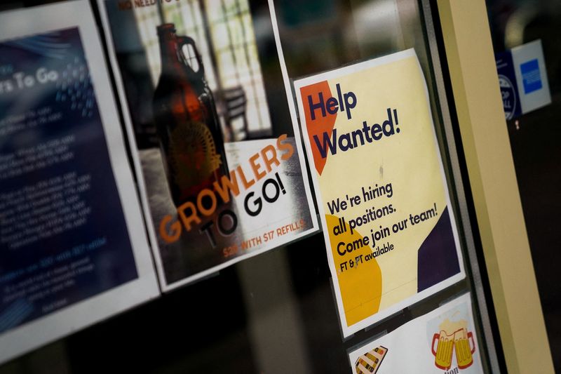 &copy; Reuters. FILE PHOTO: An employee hiring sign is seen in a window of a business in Arlington, Virginia, U.S., April 7, 2023. REUTERS/Elizabeth Frantz/File Photo