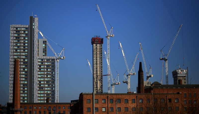 &copy; Reuters. FILE PHOTO: Construction cranes are seen above a refurbished Mill building in the city centre of Manchester, Britain, February 23, 2019. REUTERS/Phil Noble/File Photo