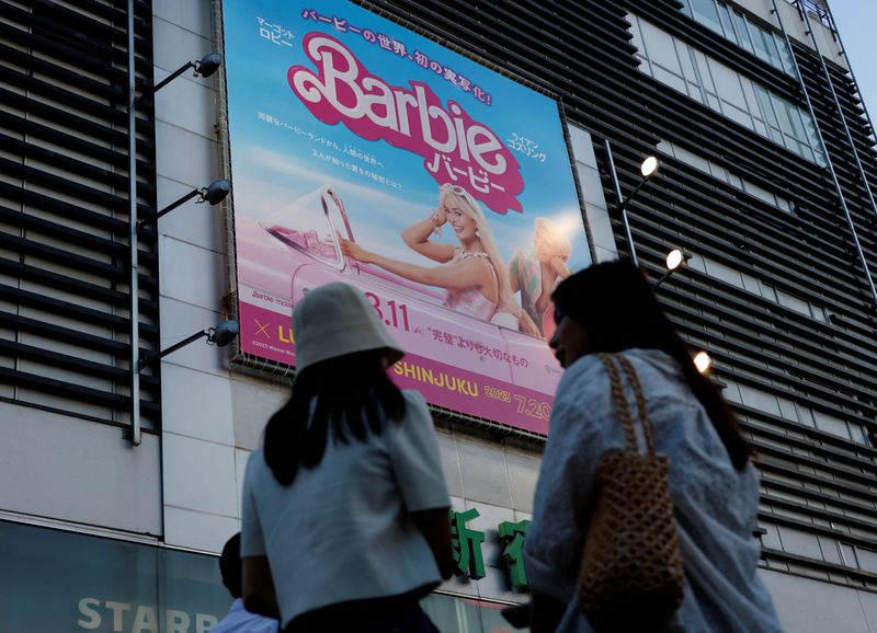 &copy; Reuters. FILE PHOTO: Women stand in front of a promotional poster of film "Barbie" in Tokyo, Japan, August 3, 2023. REUTERS/Kim Kyung-Hoon/File Photo