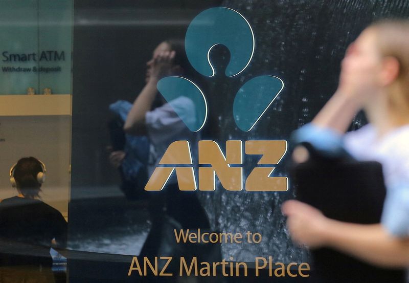 &copy; Reuters. FILE PHOTO: A pedestrian is reflected in the window of a branch of the Australia and New Zealand Banking Group (ANZ) in central Sydney, Australia, October 25, 2017. Picture taken October 25, 2017. REUTERS/Steven Saphore/File Photo