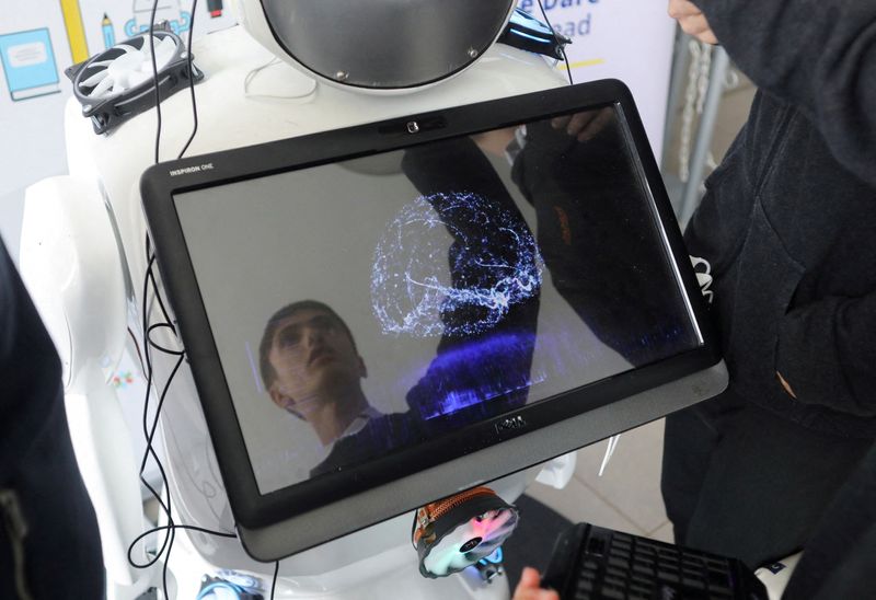 © Reuters. FILE PHOTO: High school student Richard Erkhov is reflected on a screen of 