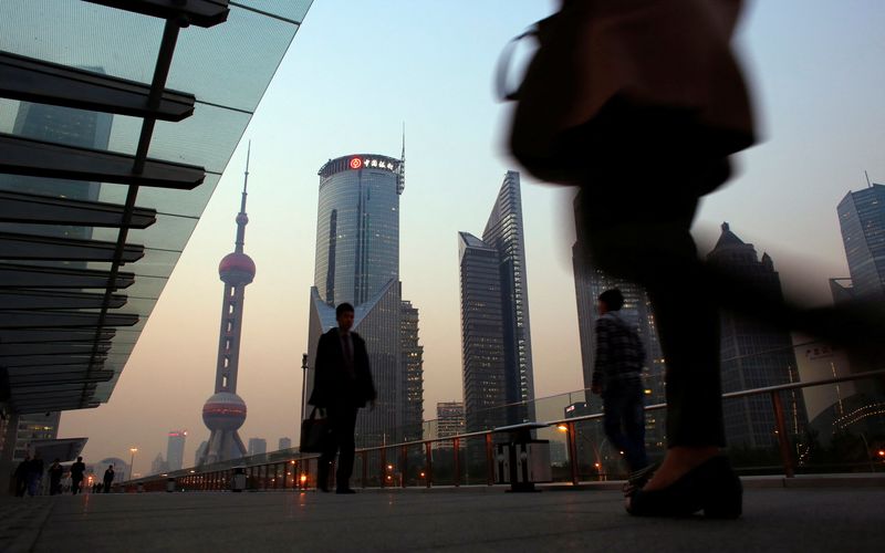 &copy; Reuters. FILE PHOTO: People walk along an elevated walkway at the Pudong financial district in Shanghai November 20, 2013.      REUTERS/Carlos Barria/File Photo